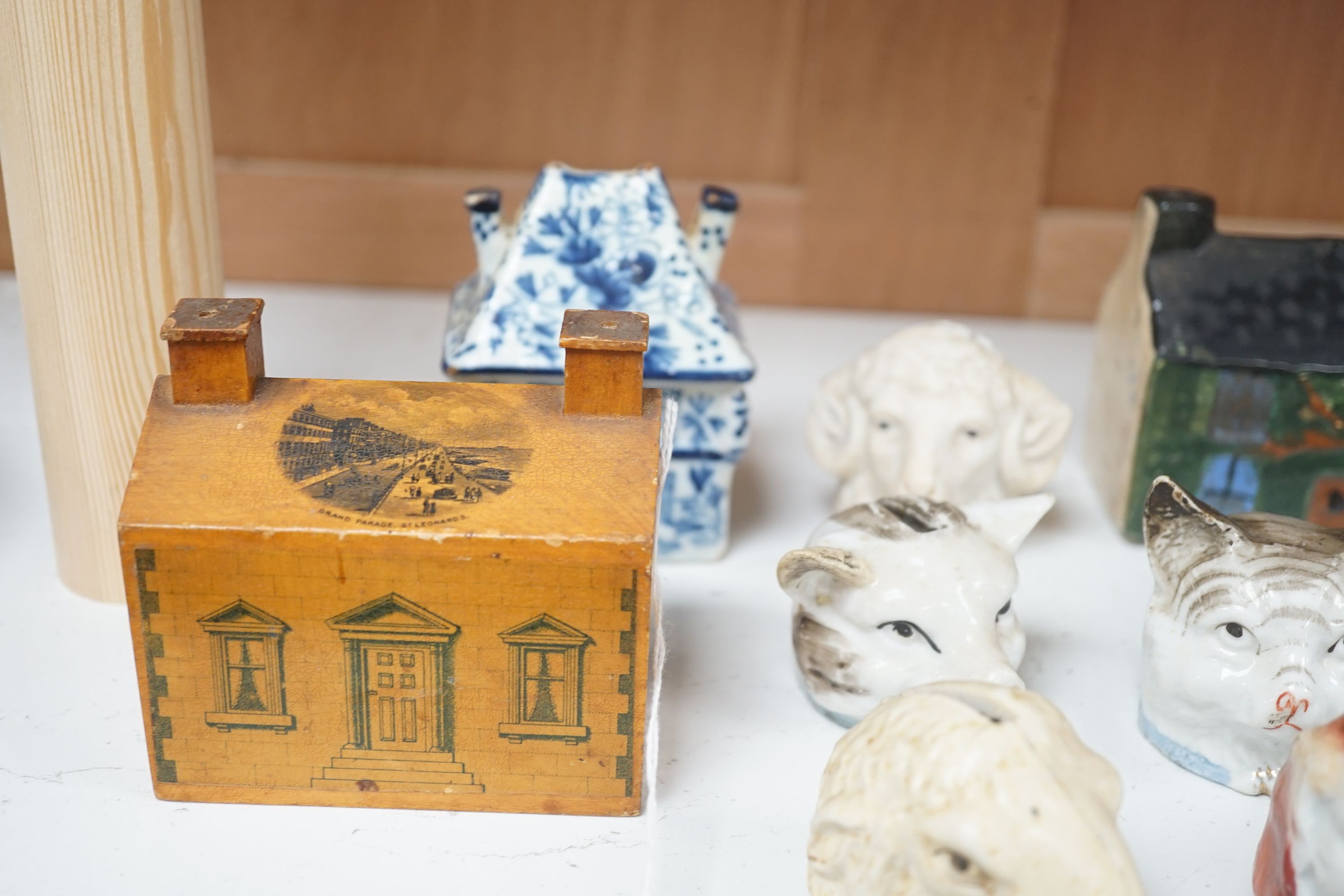 A 19th century Mauchline ware money box, together with fifteen other 19th century ceramic money boxes, Mauchline money box 8.5 cms high.